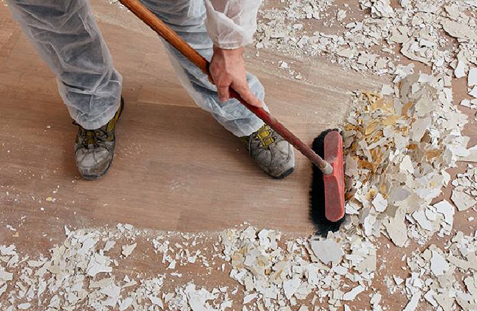 A person cleaning construction debris