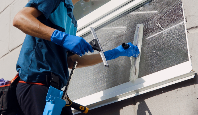 Expert cleaning window glass using equipment.