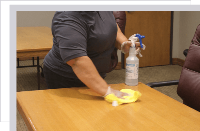 A person cleaning up an office desk