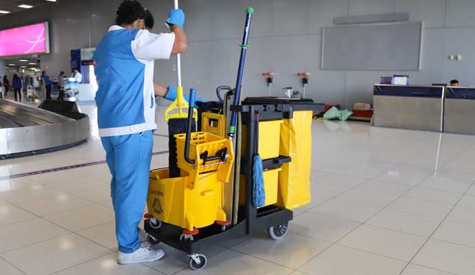 A janitor cleaning a public indoor space