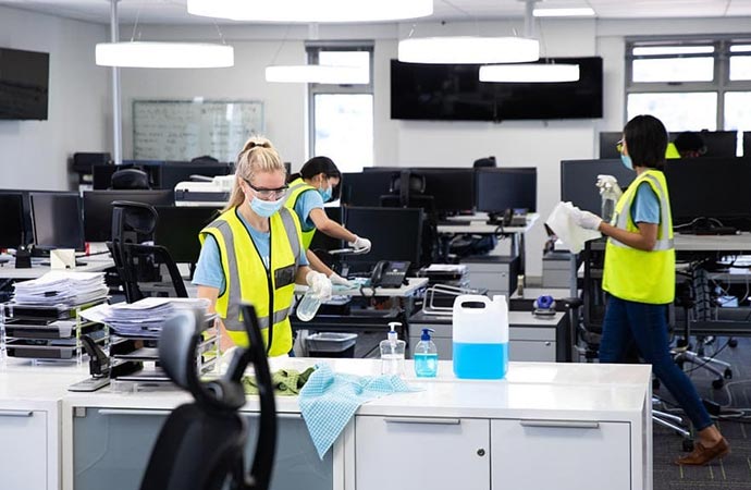 Person cleaning office with equipment