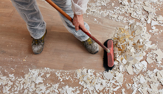 floor sweeping the laminate floor after construction work