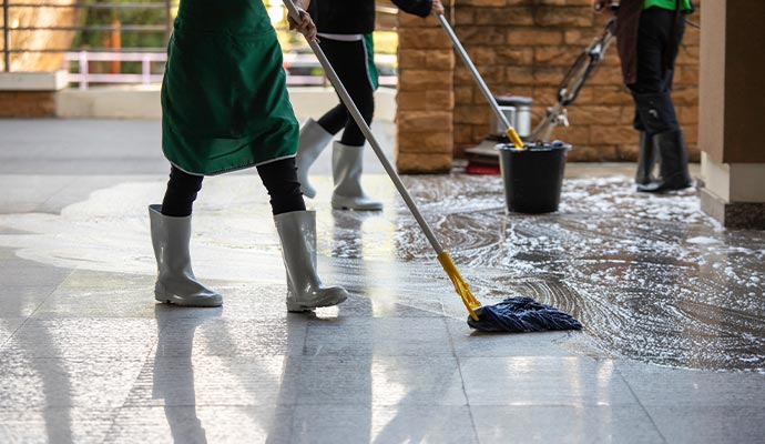 Expert team cleaning floor using equipment