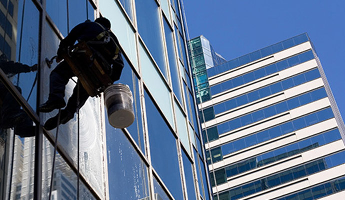 A person cleaning window with equipment